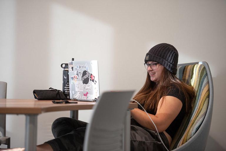 Student connecting to class online using a laptop